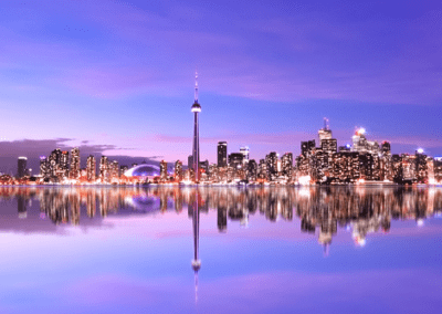 Toronto skyline reflected in the water at dusk.
