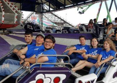 A group of people sitting on a ride at an amusement park.