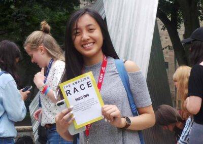 A young woman holding up a sign with the word race.