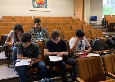 A group of students sitting in a lecture hall.