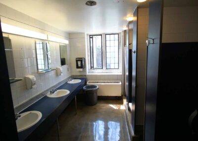 A bathroom with two sinks and a window.