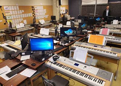 A classroom full of keyboards and computers.