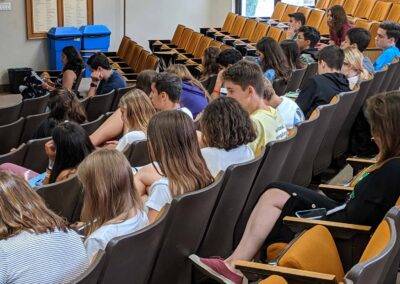 A large group of people sitting in a lecture hall.