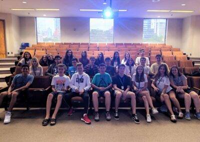 A group of students posing for a photo in an auditorium.